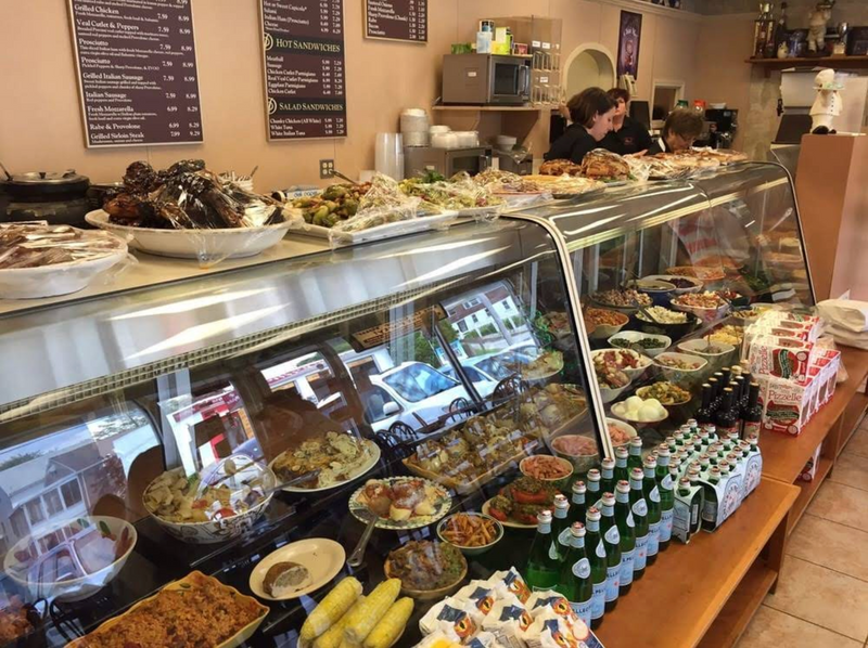 deli storefront with empoyees prepping in the background